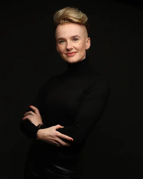 Portrait of Magdalena Czajor in a black top, arms crossed, smiling